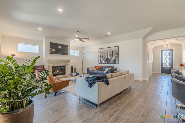 living room featuring light hardwood / wood-style flooring and ceiling fan