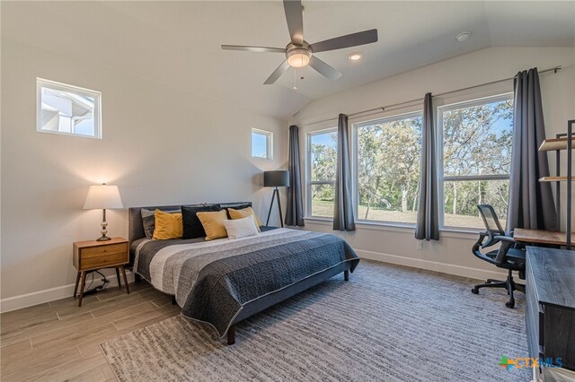 bedroom with lofted ceiling, light hardwood / wood-style floors, and ceiling fan