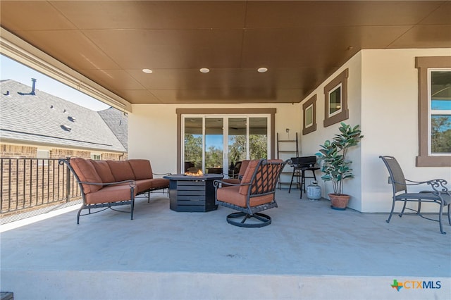 view of patio / terrace with an outdoor living space with a fire pit