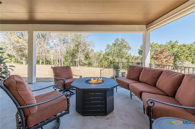 view of patio / terrace with an outdoor living space with a fire pit