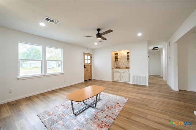 unfurnished living room with ceiling fan and light hardwood / wood-style floors