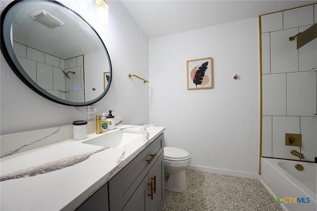 full bathroom featuring tile patterned flooring, vanity, tiled shower / bath, and toilet