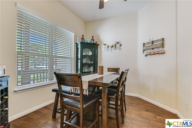 dining area featuring dark wood-type flooring and ceiling fan