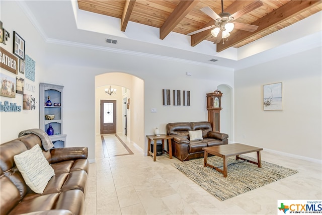 living room featuring beamed ceiling, wood ceiling, ornamental molding, and ceiling fan with notable chandelier