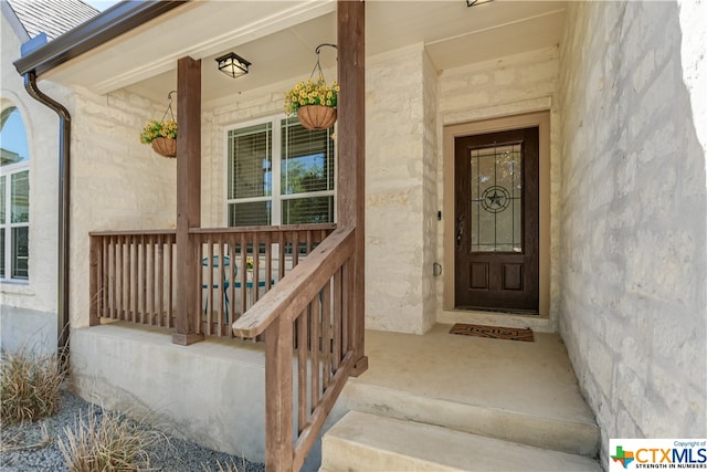 entrance to property featuring covered porch