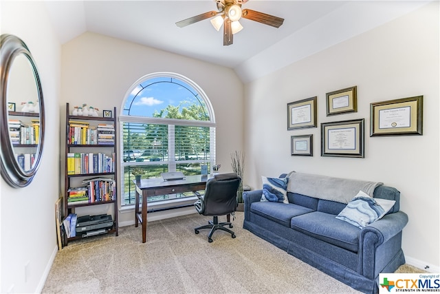 office space featuring light colored carpet, ceiling fan, and vaulted ceiling