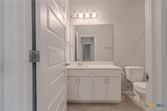 2800 Joe Dimaggio Blvd Unit 95, Round Rock, TX 78665 - half bath featuring toilet, vanity, tile patterned floors, and baseboards