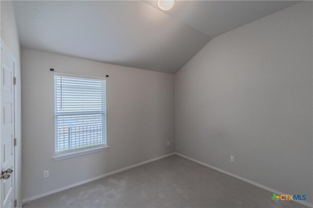 2800 Joe Dimaggio Blvd Unit 95, Round Rock, TX 78665 - carpeted empty room featuring vaulted ceiling and baseboards