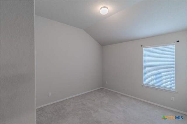 2800 Joe Dimaggio Blvd Unit 95, Round Rock, TX 78665 - spare room with carpet, lofted ceiling, and baseboards