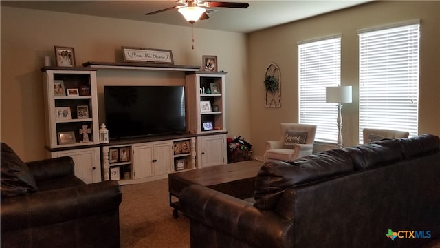 carpeted living room with ceiling fan