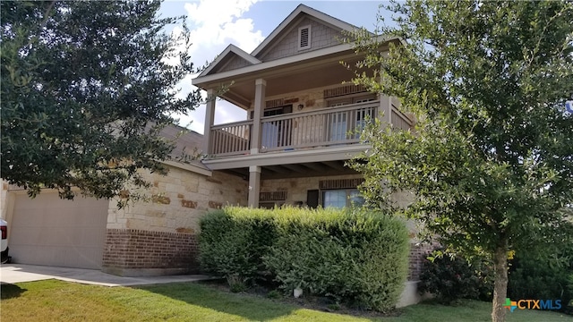 view of side of home featuring a lawn and a balcony