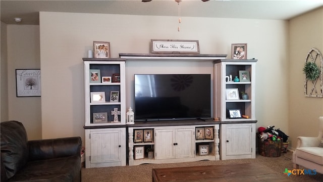 living room with ceiling fan and carpet flooring