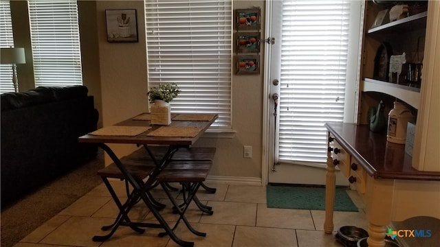 dining area with light tile patterned flooring