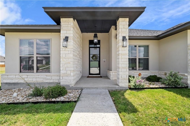 doorway to property featuring a yard