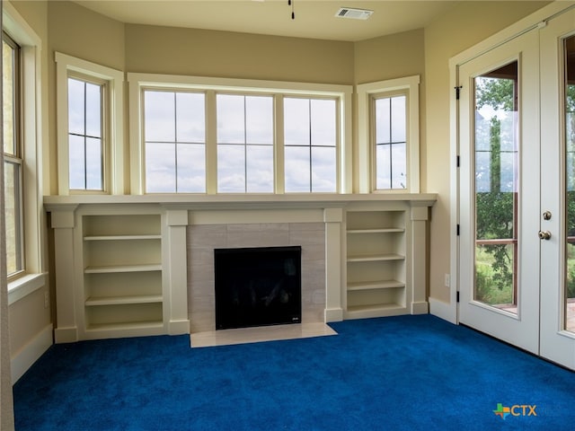 interior space featuring a wealth of natural light and dark carpet