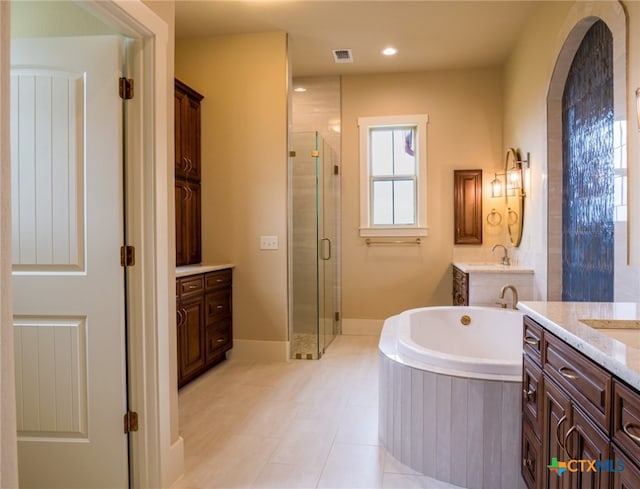 bathroom featuring tile patterned flooring, shower with separate bathtub, and vanity