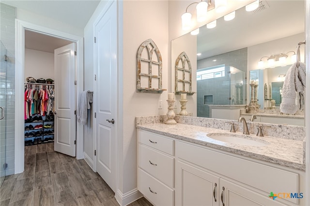 bathroom featuring vanity and an enclosed shower