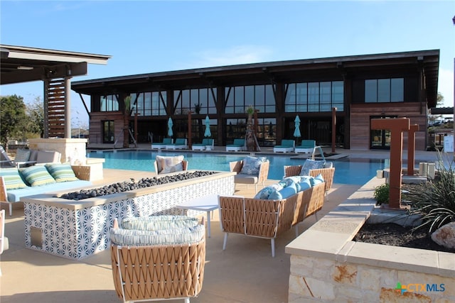 view of swimming pool featuring outdoor lounge area and a patio