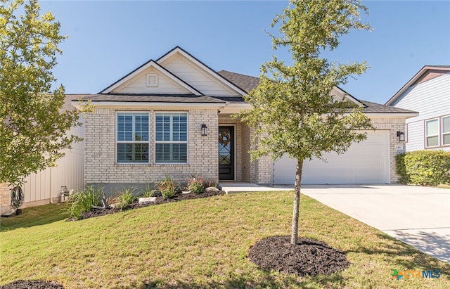 view of front of property featuring a garage and a front yard