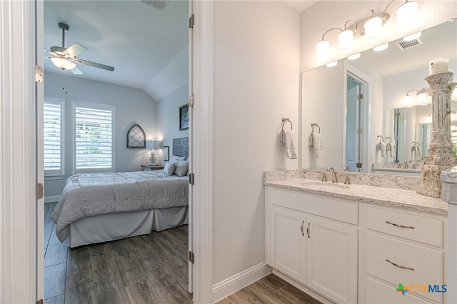 bathroom featuring ceiling fan, wood-type flooring, vanity, and lofted ceiling