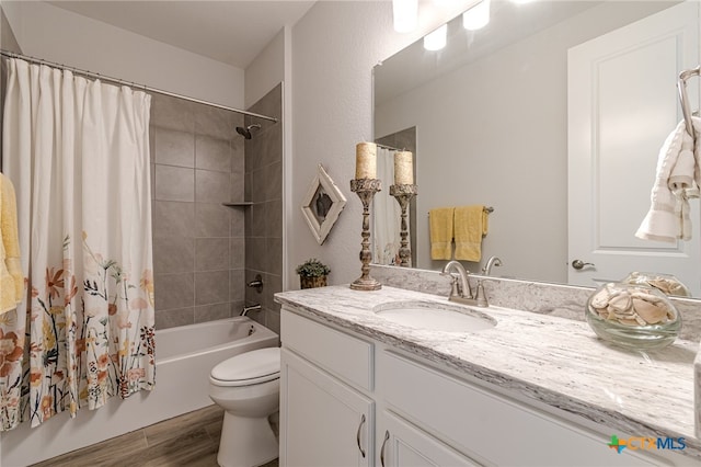 full bathroom featuring toilet, shower / tub combo, hardwood / wood-style flooring, and vanity