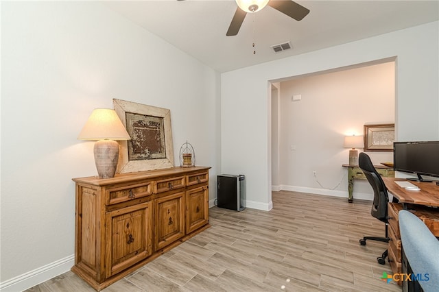 office area with light wood-type flooring and ceiling fan