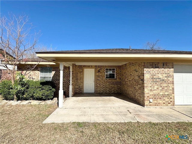 view of exterior entry with a garage