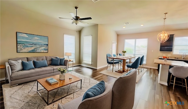 living room featuring dark hardwood / wood-style floors, ceiling fan, lofted ceiling, and sink