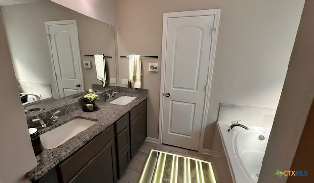 bathroom featuring tile patterned floors, vanity, and a bathtub