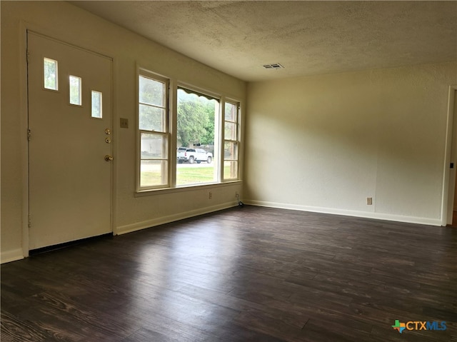 201 W Young Ave, Temple, TX 76501 - foyer with a textured ceiling, dark wood-style floors, and baseboards