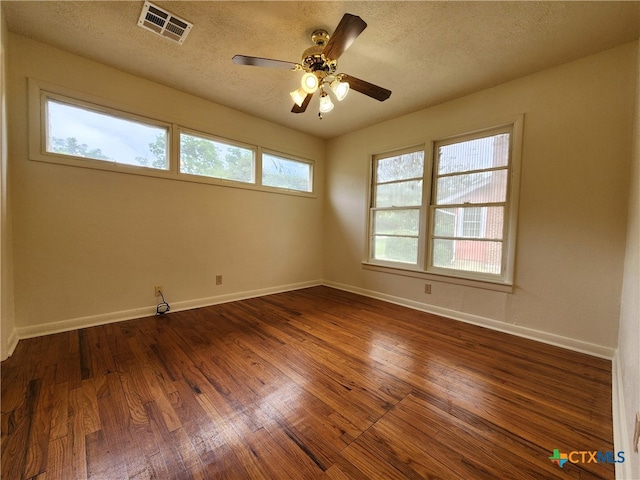 201 W Young Ave, Temple, TX 76501 - empty room with dark wood-type flooring, ceiling fan, baseboards, and a textured ceiling