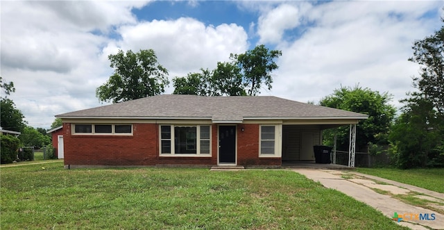 201 W Young Ave, Temple, TX 76501 - ranch-style home featuring concrete driveway, a front lawn, a carport, and brick siding