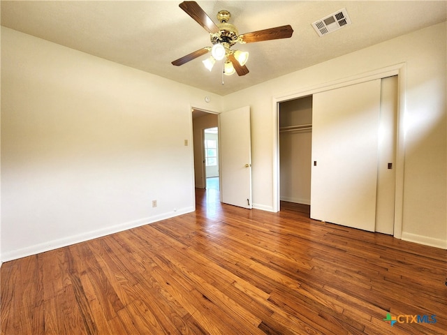 201 W Young Ave, Temple, TX 76501 - unfurnished bedroom featuring wood finished floors, baseboards, a closet, and a ceiling fan