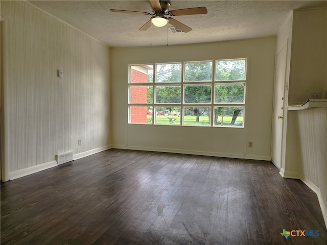 201 W Young Ave, Temple, TX 76501 - unfurnished living room with ceiling fan, dark wood-style floors, healthy amount of natural light, a textured ceiling, and baseboards