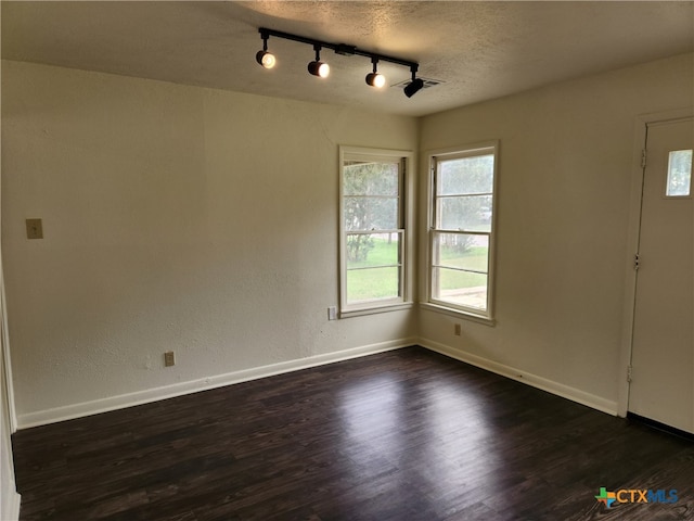 201 W Young Ave, Temple, TX 76501 - entryway with plenty of natural light, rail lighting, dark wood-style floors, and a textured ceiling