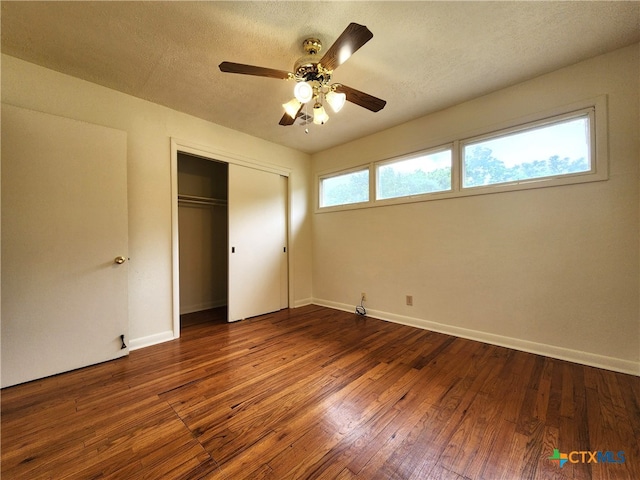 201 W Young Ave, Temple, TX 76501 - unfurnished bedroom with a closet, dark wood finished floors, baseboards, a ceiling fan, and a textured ceiling