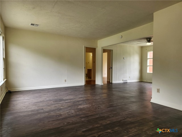 201 W Young Ave, Temple, TX 76501 - spare room featuring dark wood-style floors, a ceiling fan, baseboards, and a textured ceiling