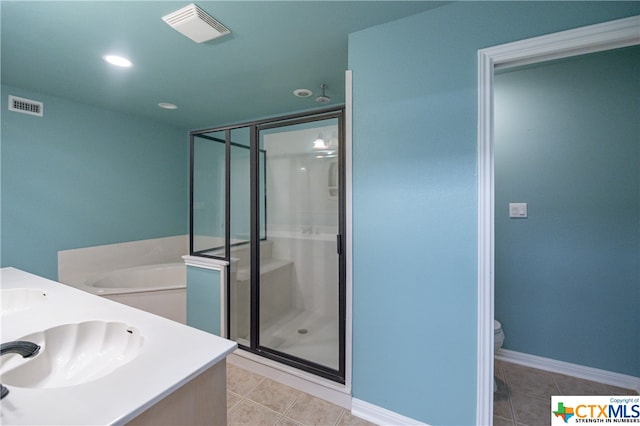 full bathroom with tile patterned flooring, vanity, toilet, and independent shower and bath