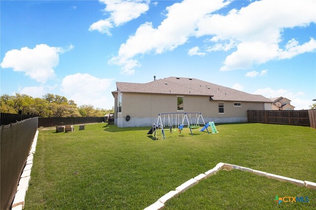 1386 Lyme Park, Bulverde, TX 78163 - back of property featuring a playground, a fenced backyard, and stucco siding