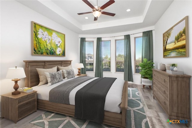 1386 Lyme Park, Bulverde, TX 78163 - bedroom with a tray ceiling, recessed lighting, light wood-style flooring, and ceiling fan