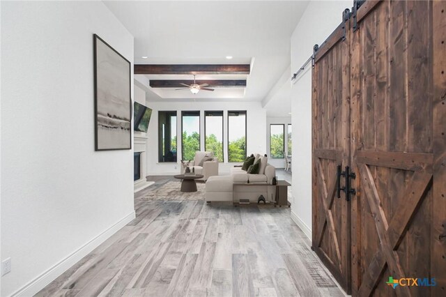 1386 Lyme Park, Bulverde, TX 78163 - hallway featuring a barn door, light wood-style floors, beam ceiling, and recessed lighting