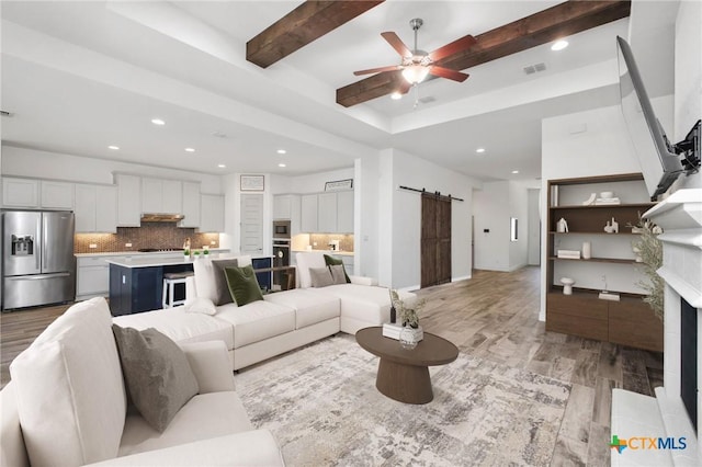 1386 Lyme Park, Bulverde, TX 78163 - living area with a barn door, light wood-type flooring, recessed lighting, a ceiling fan, and beam ceiling