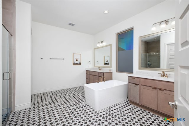 1386 Lyme Park, Bulverde, TX 78163 - bathroom with a stall shower, two vanities, a soaking tub, tile patterned floors, and recessed lighting