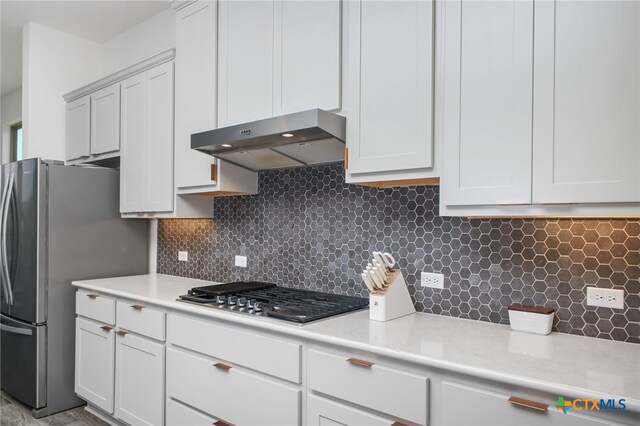 1386 Lyme Park, Bulverde, TX 78163 - kitchen featuring under cabinet range hood, appliances with stainless steel finishes, light countertops, and tasteful backsplash