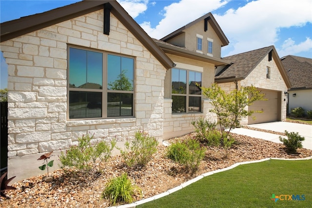 1386 Lyme Park, Bulverde, TX 78163 - view of front of property with stone siding, driveway, a garage, roof with shingles, and a front yard