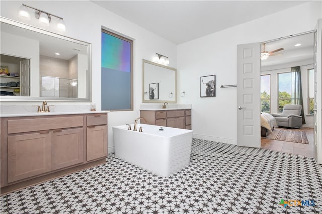 1386 Lyme Park, Bulverde, TX 78163 - ensuite bathroom featuring a stall shower, two vanities, a soaking tub, and ceiling fan