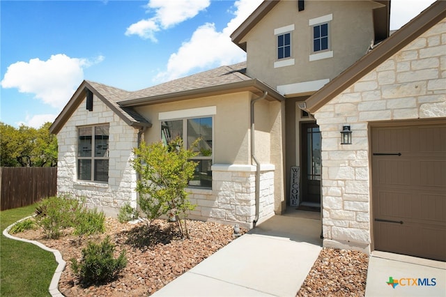 1386 Lyme Park, Bulverde, TX 78163 - doorway to property featuring stone siding, stucco siding, and roof with shingles