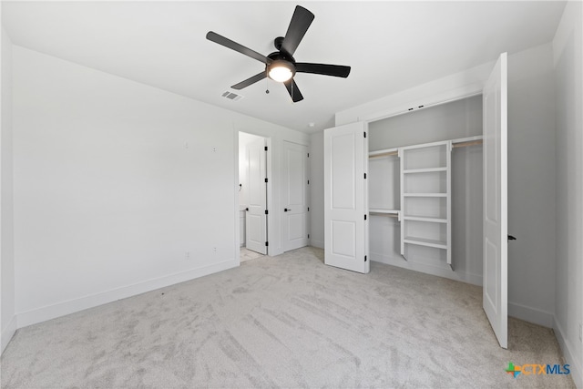 unfurnished bedroom featuring a closet, light colored carpet, and ceiling fan