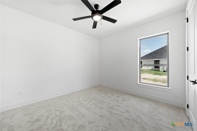 unfurnished room with light colored carpet and ceiling fan