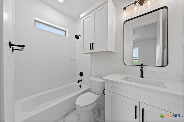 full bathroom featuring vanity, tiled shower / bath, and toilet